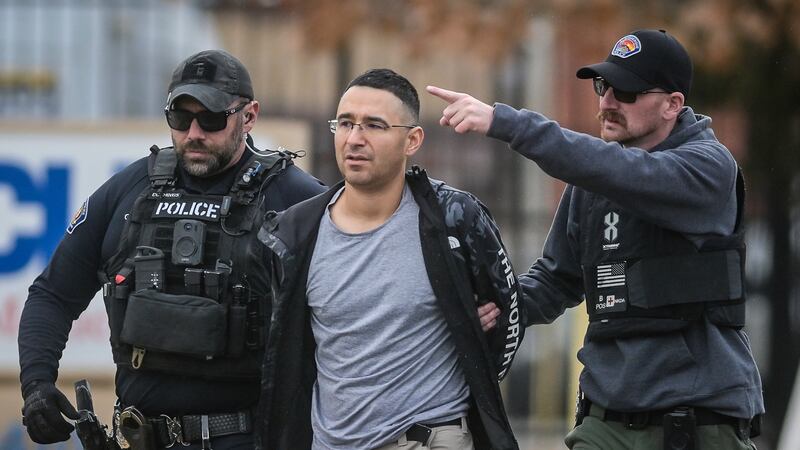 Solomon Pena, center, a Republican candidate for New Mexico House District 14, is taken into...
