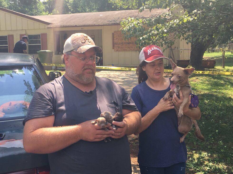 Lisa and Allen Rounds hold Coco and her puppies, who survived a fire at their Huntsville home...