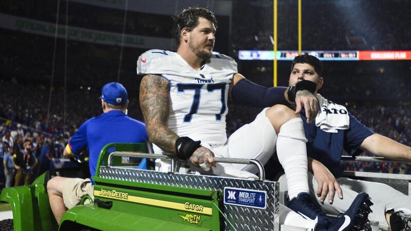 Tennessee Titans offensive tackle Taylor Lewan (77) is carted off the field during the first...