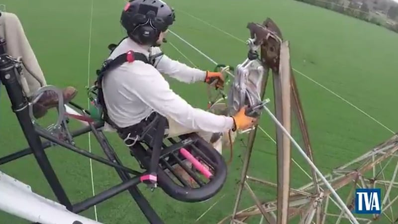 A TVA lineman works on a transmission tower (Source: TVA)
