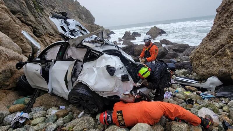 The Tesla sedan plummeted more than 250 feet from the highway and crashed into a rocky...