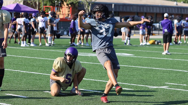 Kicker, Sam Contorno and quarterback Noah Walters holding the ball