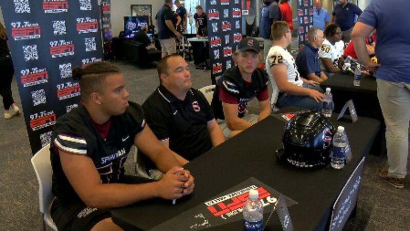 Sparkman High School Head Football Coach Ronnie Watson (center) meets with Media at an area...