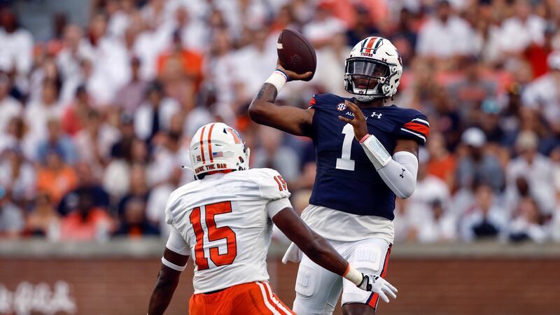 Auburn quarterback T.J. Finley (1) throws a pass as Mercer linebacker Ken Standley (15)...