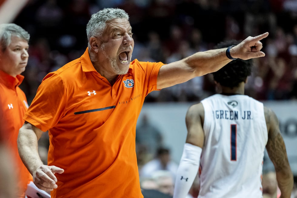 Auburn coach Bruce Pearl gives the team instruction during the first half of an NCAA college...