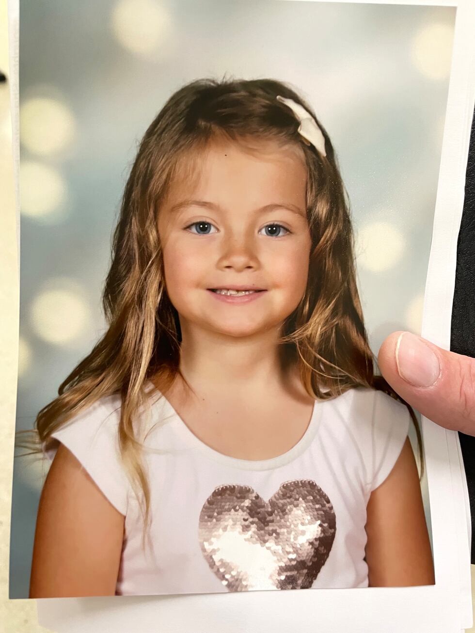 Jim Cappello's family hold a photo of daughter Riley following Nikki's life sentence